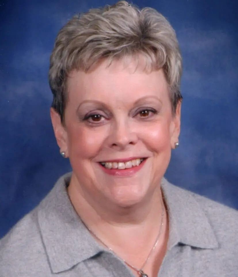 Smiling woman with short gray hair.